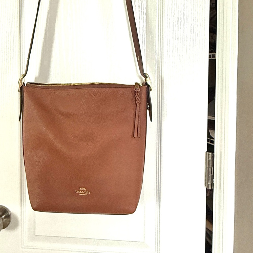 Brown, COACH, bag with adjustable strap with gold buckle and gold emblem. NWOT